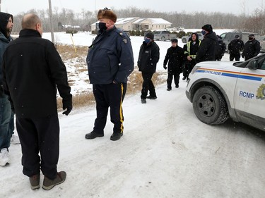 RCMP advise Patrick Allard (left), organizer of the Manitoba Together public health policy protest group, and Todd Dube they are not to enter the grounds of Church of God, south of Steinbach, Man., on Sunday, Nov. 29, 2020.