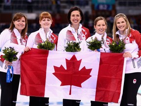 (Right to left) Gold medalists Jennifer Jones, Kaitlyn Lawes, Jill Officer, Dawn McEwen and Kirsten Wall of Canada celebrate during the flower ceremony for the Gold medal match between Sweden and Canada on day 13 of the Sochi 2014 Winter Olympics at Ice Cube Curling Center on Feb. 20, 2014 in Sochi, Russia.