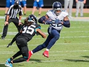 Tennessee Titans running back Derrick Henry (22) runs the ball past Jacksonville Jaguars cornerback Sidney Jones (35) during the second quarter at TIAA Bank Field on Sunday. Henry ran for 215 yards and had two touchdowns in the Titans' win.