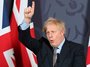 Britain's Prime Minister Boris Johnson gestures as he holds a remote press conference to update the nation on the post-Brexit trade agreement on December 24, 2020.