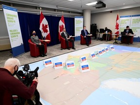 Canada's Chief Public Health Officer Dr. Theresa Tam, and Major-General Dany Fortin, join other members of the vaccine distribution task force as the Canadian Armed Forces and the Public Health Agency of Canada (PHAC) hold a rehearsal of concept drill for the coronavirus vaccine for rollout at the PHAC headquarters in Ottawa, Dec. 11, 2020.
