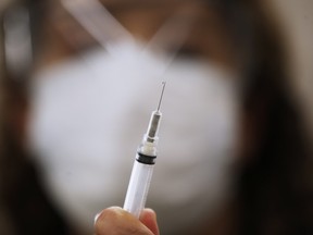 LoriAnn Laramee, public health nurse, prepares dilutant for the COVID-19 vaccine in the COVID-19 vaccination clinic at the Health Sciences Centre in Winnipeg, Wednesday, December 16, 2020.  Qualified Manitobans received their first inoculation in the COVID-19 vaccination.  John Woods/The Canadian Press/Pool