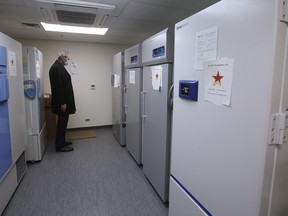 Brian Pallister, Premier of Manitoba, looks at the special -80 degree freezers at the COVID-19 vaccination clinic at the Health Sciences Centre in Winnipeg, Monday, December 14, 2020.  THE CANADIAN PRESS/John Woods