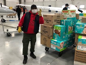 Byron Beardy, food security manager with Four Arrows Regional Health Authority gives the OK on a recent shipment of essential items headed for the Island Lake community, at the Fast Air Terminal in Winnipeg.