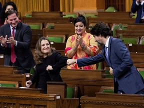 Canada's Finance Minister Chrystia Freeland receives a fist-bump from Prime Minister Justin Trudeau after unveiling her first fiscal update in the House of Commons, in Ottawa November 30, 2020.