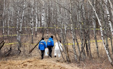 Cadets assist a member of the forensic identification unit into an area of the Assiniboine Forest where human remains were found, on Sun., April 19, 2020. Kevin King/Winnipeg Sun/Postmedia Network
