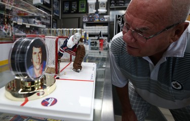Former Winnipeg Jets goaltender Joe Daley leans in for a look at an original artwork created by Clyde Raven which was unveiled to Daley and his sports and framing store on St. Mary's Road in Winnipeg on Thurs., June 18, 2020. Kevin King/Winnipeg Sun/Postmedia Network