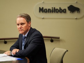 Manitoba Health Minister Cameron Friesen looks on during the daily briefing at the Manitoba Legislative Building, in Winnipeg, Thursday, Aug. 27, 2020. The Manitoba government has signed an agreement with the Manitoba Nurses Union that will allow nurses to be shifted to priority areas to deal with COVID-19 cases.