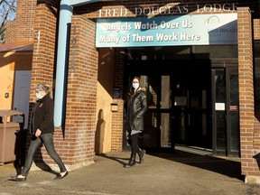 Health-care workers exit Fred Douglas Lodge personal care home on Burrows Avenue in Winnipeg on Thursday, Dec. 10, 2020.