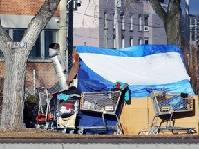 A tent with apparent indoor heat sits outside the barricade of a former homeless encampment on the Disraeli Freeway near Henry Avenue in Winnipeg on Thurs., Dec. 10, 2020. Kevin King/Winnipeg Sun/Postmedia Network
