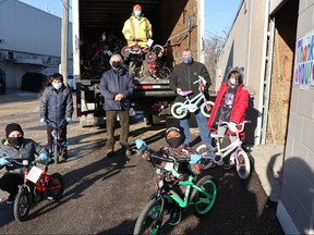 Students from Victor Mager School in Winnipeg help unload 180 refurbished bikes donated to the school by The WRENCH (Winnipeg Repair Education and Cycling Hub) on Thursday, Dec. 10, 2020. “These kids and these families don’t take anything for granted, so they know what an amazing gift this is for a school like ours,” said Victor Mager School’s Principal Troy Reinhardt.