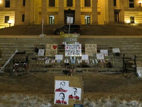 A group of concerned Manitobans put together a vigil at the steps of the Manitoba Legislature in Winnipeg early Sunday morning to remember those lost to the pandemic and to show support for frontline workers and call for a better COVID-19 response from the provincial government. Signs, some reading 'Manitobans deserve better' and "We are all in this together', were left on the steps leading up to the Legislature along with a wheelchair, crutches, a walker and pairs of shoes.