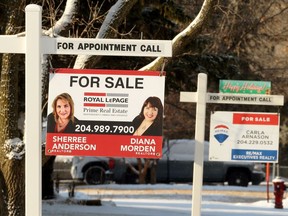 Real estate for sale signs on Betsworth Avenue in the Charleswood area of Winnipeg on Sunday.
