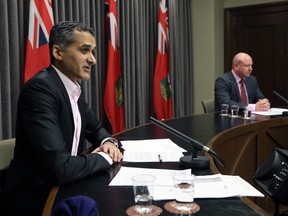 Dr. Jazz Atwal (left), acting deputy chief provincial health officer, speaks during a COVID-19 briefing at the Manitoba Legislative Building in Winnipeg on Wed., Dec. 16, 2020. At left is Dr. Brent Roussin, chief provincial public health officer. Kevin King/Winnipeg Sun/Postmedia Network
