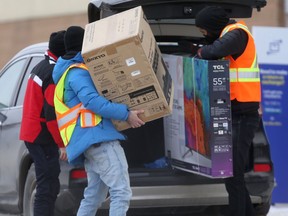 Curbside Boxing Day pickup at an electronics store in Winnipeg on Saturday.