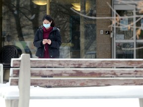 A woman wearing a mask exits Poseidon Care Centre on Poseidon Bay in Winnipeg on Monday, Dec. 28, 2020.