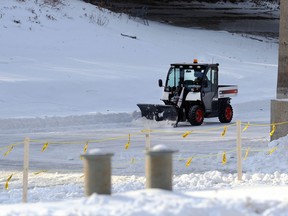 A plow removes snow along the river trail near the historic port at The Forks in Winnipeg on Tues., Dec. 29, 2020. The canopy rink and portions of the trail on land are the only areas open for skating at the Forks so far, with more trail promised before New Year's Eve. Kevin King/Winnipeg Sun/Postmedia Network
