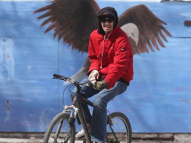 A person appears to have large wings as they pass a mural in Winnipeg Thursday April 16, 2020.