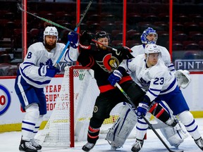 Ottawa Senators centre Derek Stepan battles with Toronto Maple Leafs defenceman Jake Muzzin (left) and defenseman Travis Dermott in front of goaltender Frederik Andersen on Friday night.