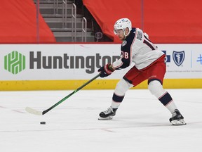Columbus Blue Jackets center Pierre-Luc Dubois (18) brings the puck up ice to score a goal against the Detroit Red Wings during the third period at Little Caesars Arena in Detroit on Jan. 18, 2021.