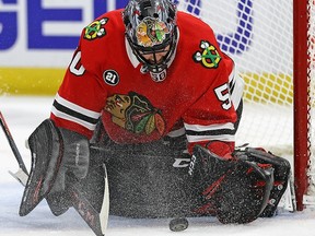 Corey Crawford of the Chicago Blackhawks makes a save against the Winnipeg Jets at the United Center on December 14, 2018 in Chicago.
