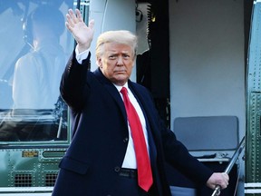 Outgoing U.S. President Donald Trump waves as he boards Marine One at the White House in Washington, D.C., on Wednesday, Jan. 20, 2021.