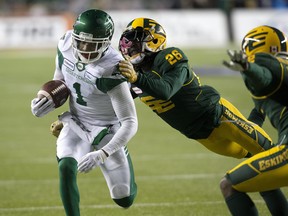 The Edmonton Eskimos' Josh Johnson (26) tackles the Saskatchewan Roughriders' Shaq Evans (1) during second half CFL action at Commonwealth Stadium in Edmonton Saturday Oct. 26, 2019. Saskatchewan won 27 to 24.