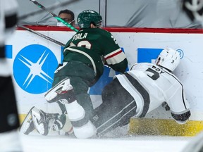 Wild left wing Kevin Fiala (left) commits a boarding penalty against Kings defenceman Matt Roy (right) during NHL action in Saint Paul, Minn., Thursday, Jan. 28, 2021.