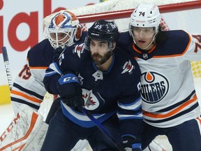 When he plays at least 60 games, Winnipeg Jets forward Mathieu Perreault (centre) has averaged 15 goals a season over a career going on 12 years, a number that’s remained consistent in Washington, Anaheim and Winnipeg. Kevin King/Winnipeg Sun