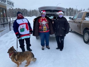 On Dec. 23, 2020, three seniors delivered hampers as part of the Food on the Table for Winter initiative in Thompson, Man. (From left) Molly Stapleton, Linda Dearman and Jean Pankratz (with assistance from Molly the dog). All three ladies are board members of the Thompson Seniors Community Resource Council, Inc.