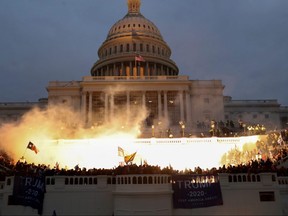 An explosion caused by a police munition is seen while supporters of U.S. President Donald Trump gather in front of the U.S. Capitol Building in Washington, U.S., on January 6, 2021.