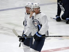 Nikolaj Ehlers (left) and Kyle Connor talk during Winnipeg Jets training camp at the Bell MTS Iceplex in Winnipeg on Thurs., Jan. 7, 2021.