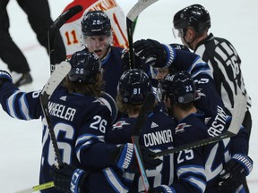 The Winnipeg Jets celebrate a second-period power play goal against the Calgary Flames on Thursday night.