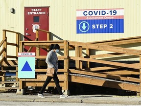 A person walks past a COVID-19 assessment centre during the COVID-19 pandemic in Scarborough, Ont., on Wednesday, December 2, 2020.