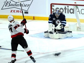 Ottawa Senators forward Brady Tkachuk tries to get a shot past Winnipeg Jets goalie Connor Hellebuyck during the third period at Bell MTS Place on Saturday.