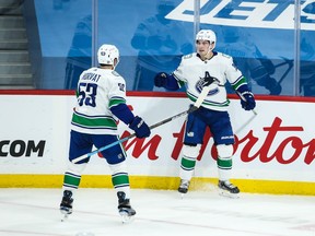 Vancouver Canucks forward Nils Hoglander (36) is congratulated by Vancouver Canucks forward Bo Horvat (53) on his goal against the Winnipeg Jets during the first period at Bell MTS Place in Winnipeg on Saturday, Jan. 30, 2021.