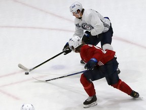 Mark Scheifele (top) is defended by Josh Morrissey during Winnipeg Jets training camp at Bell MTS Iceplex in Winnipeg on Monday.