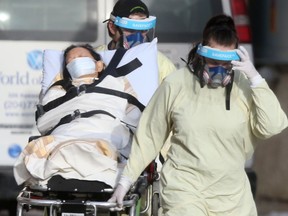 Three people wearing masks near a hospital in Winnipeg  on Wednesday January 6, 2021. Chris Procaylo/Winnipeg Sun