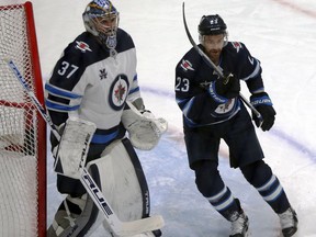 Trevor Lewis takes up position in front of goaltender Connor Hellebuyck during a scrimmage at Winnipeg Jets training camp at Bell MTS Iceplex in Winnipeg on Wed., Jan. 6, 2021. Kevin King/Winnipeg Sun/Postmedia Network