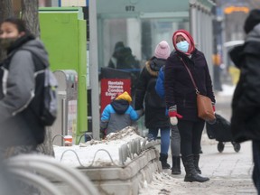 People wearing masks while in public, in Winnipeg on Friday.