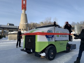 Richard Frost, Winnipeg Foundation CEO (right), drives a Zamboni through the tape held by The Forks CEO Paul Jordan (far left) to officially open The Winnipeg Foundation Centennial River Trail at The Forks in Winnipeg on Tuesday. Celebrating its 100th anniversary this year, The Winnipeg Foundation distributed $73 million to approximately 1,000 charitable organizations in 2020, it was announced at a press conference at The Forks.