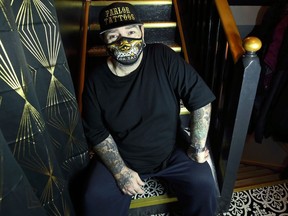 Phil McLellan, The Parlor Tattoos owner, poses for a photo in his Winnipeg home on Monday, Jan. 11, 2021.