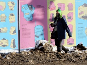 A woman wearing a mask walks on Osborne Street in Winnipeg on Wed., Jan. 13, 2021. Kevin King/Winnipeg Sun/Postmedia Network