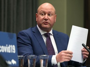 Dr. Brent Roussin, the chief provincial public health officer, wraps up his initial remarks during a press briefing at the Manitoba Legislative Building in Winnipeg on Monday.