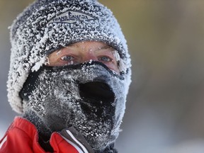 A runner is covered in frost from a mid morning workout, in Winnipeg on Tuesday, Jan. 26, 2021.