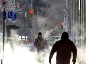 Sunny skies, extreme cold, and exhaust fog create a high contrast street scene, in Winnipeg on Tuesday, Jan. 26, 2021.