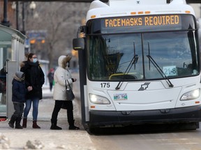 People wearing masks at a bus stop in Winnipeg. Thursday, January 28, 2/2021.Winnipeg Sun/Chris Procaylo/stf