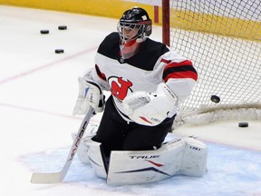 Eric Comrie of the New Jersey Devils skates in warm-ups prior to the game against the New York Islanders at Nassau Coliseum on January 21, 2021 in Uniondale, New York. Comrie is rejoining the Jets after the team picked him off the waiver wire. (Photo by Bruce Bennett/Getty Images)