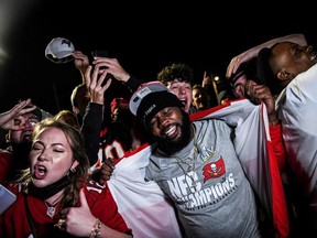 Masks are for losers! Tampa fans whoop it up after the Bucs Super Bowl win.