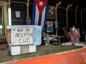 In this file photo taken on Sept. 15, 2020 a sign reading "CUC not accepted" is seen at a grocery store in Havana.